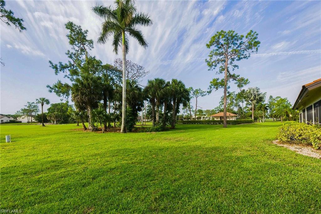 646 Augusta Boulevard Naples, FL 34113 - Photo 39 of 43 a view of a garden with a building in the background