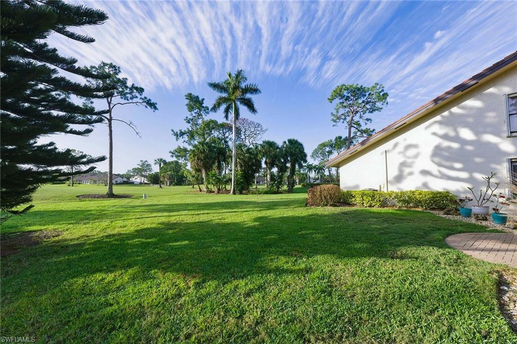 646 Augusta Boulevard Naples, FL 34113 - Photo 40 of 43 a front view of a house with garden