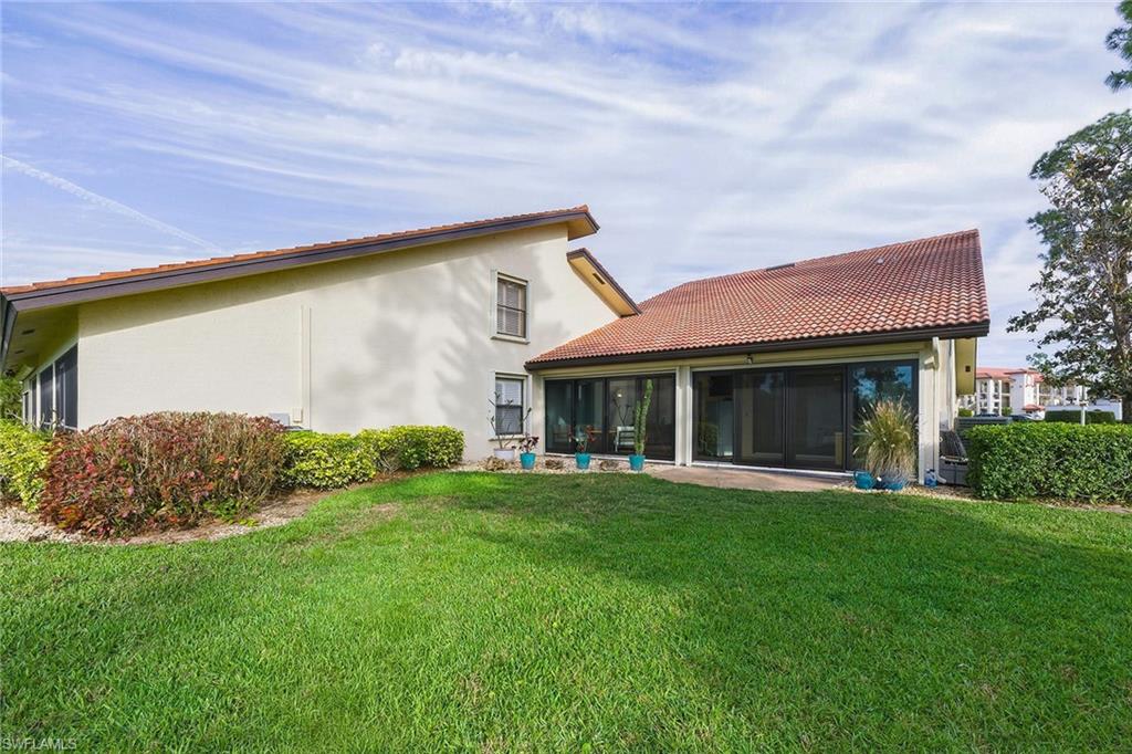 646 Augusta Boulevard Naples, FL 34113 - Photo 41 of 43 a front view of a house with a yard