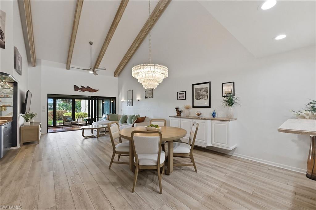 646 Augusta Boulevard Naples, FL 34113 - Photo 8 of 43 a view of a dining room with furniture a chandelier and wooden floor
