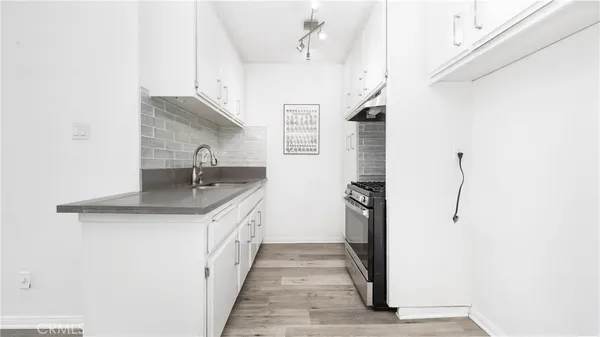a kitchen with stainless steel appliances granite countertop a sink and refrigerator