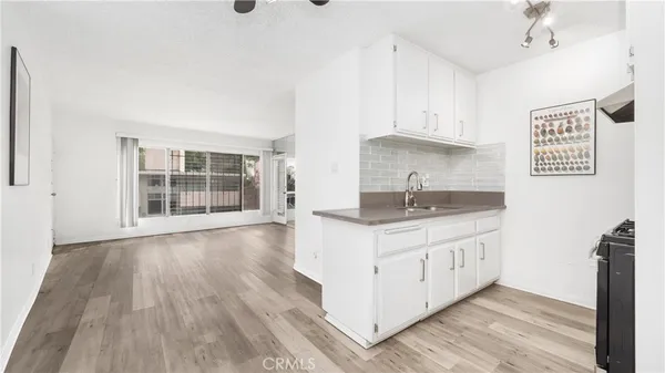 a kitchen with granite countertop a sink and a stove top oven