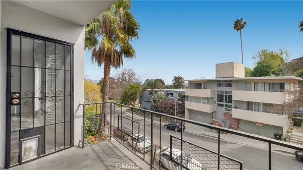 a view of a balcony with a floor to ceiling window and wooden floor