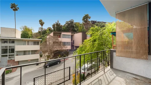 a view of a house with a tree beside it
