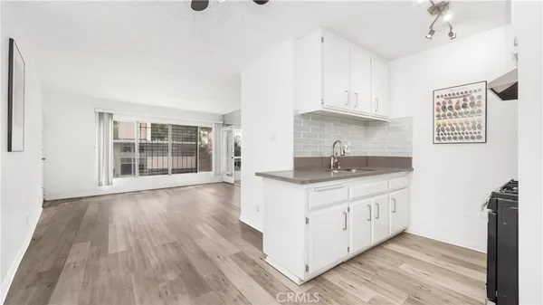 a kitchen with granite countertop a sink and a stove top oven