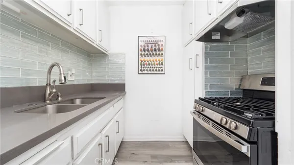 a kitchen with granite countertop a sink and cabinets