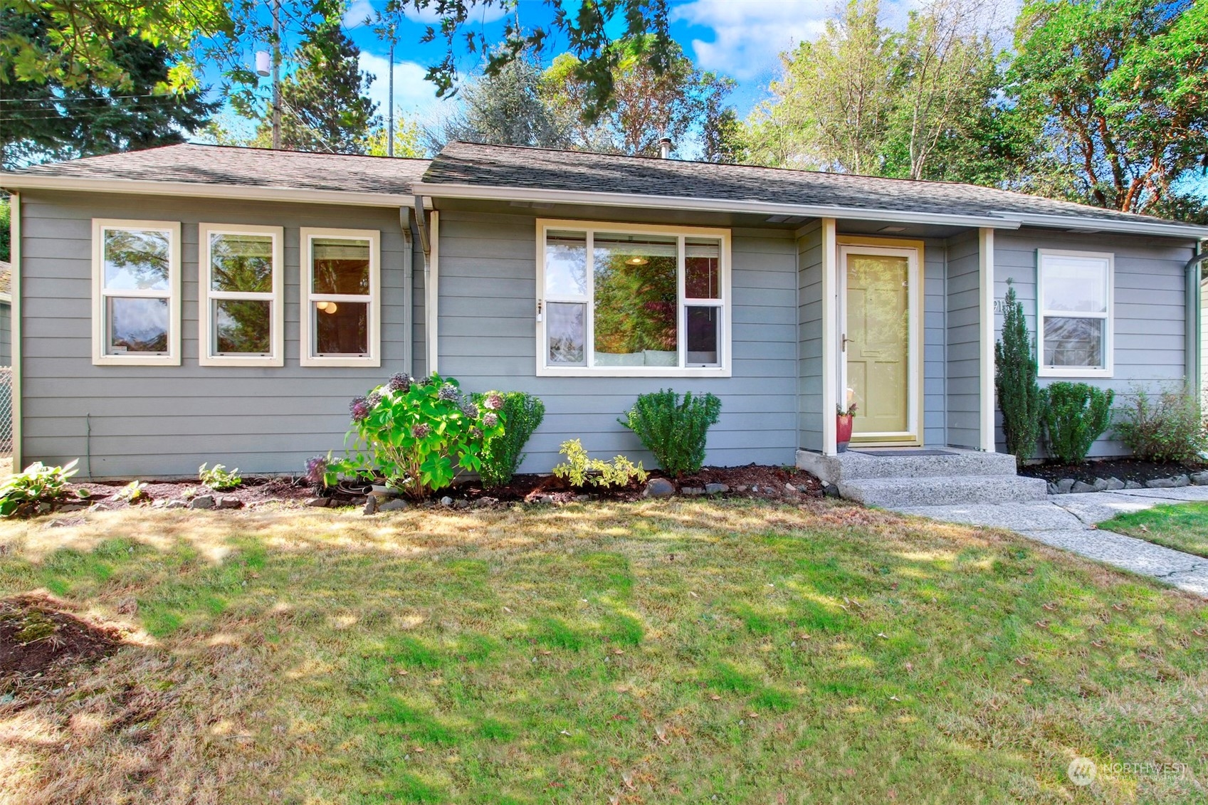 9913 32nd Avenue Southwest Seattle, WA 98126 - Photo 1 of 29 a front view of a house with a yard and porch