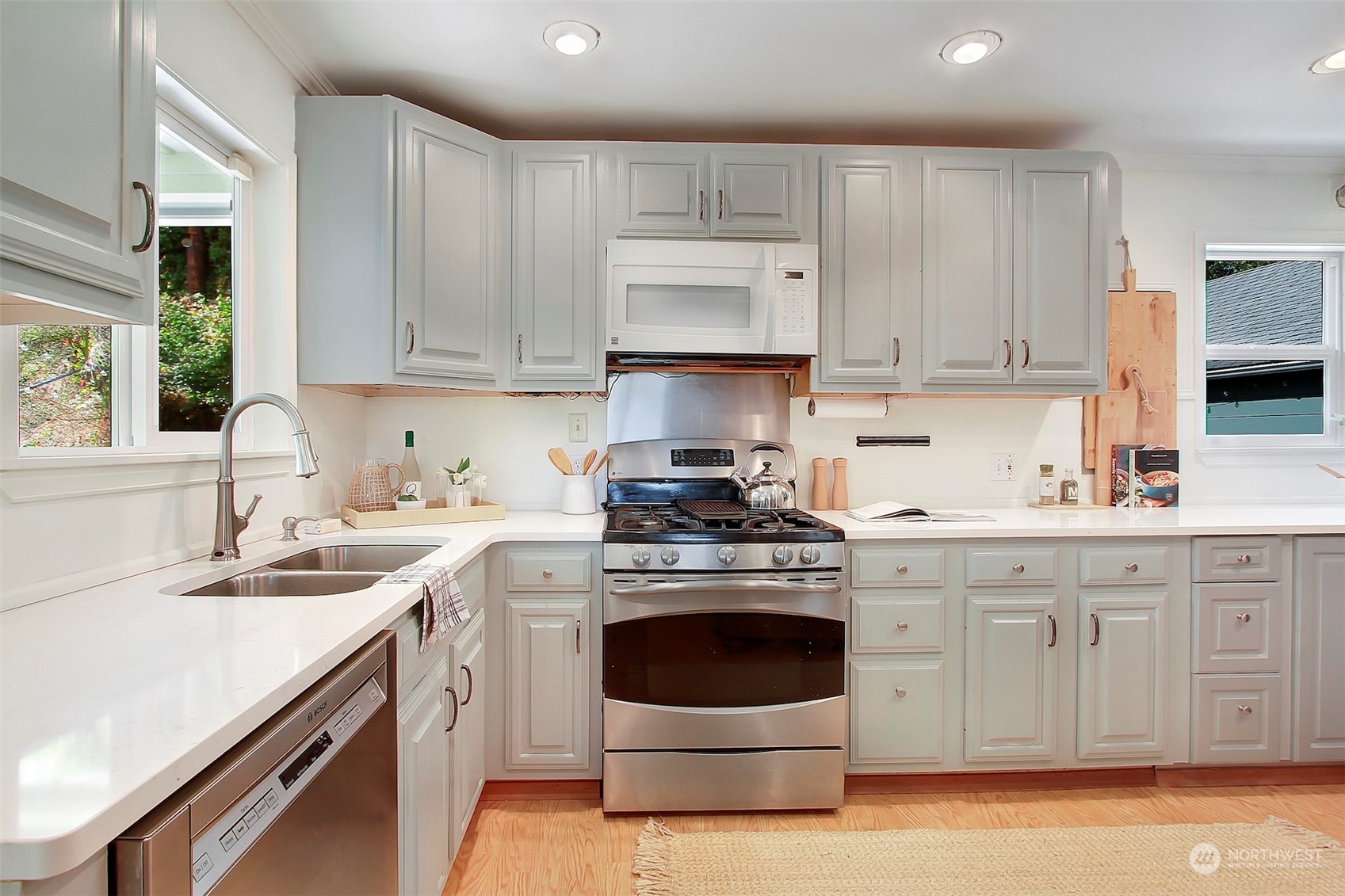 9913 32nd Avenue Southwest Seattle, WA 98126 - Photo 12 of 29 a kitchen with a stove top oven sink and cabinets