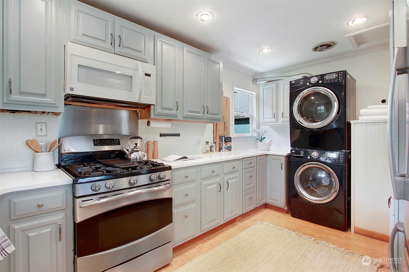 9913 32nd Avenue Southwest Seattle, WA 98126 - Photo 13 of 29 a kitchen with stove top oven and cabinets