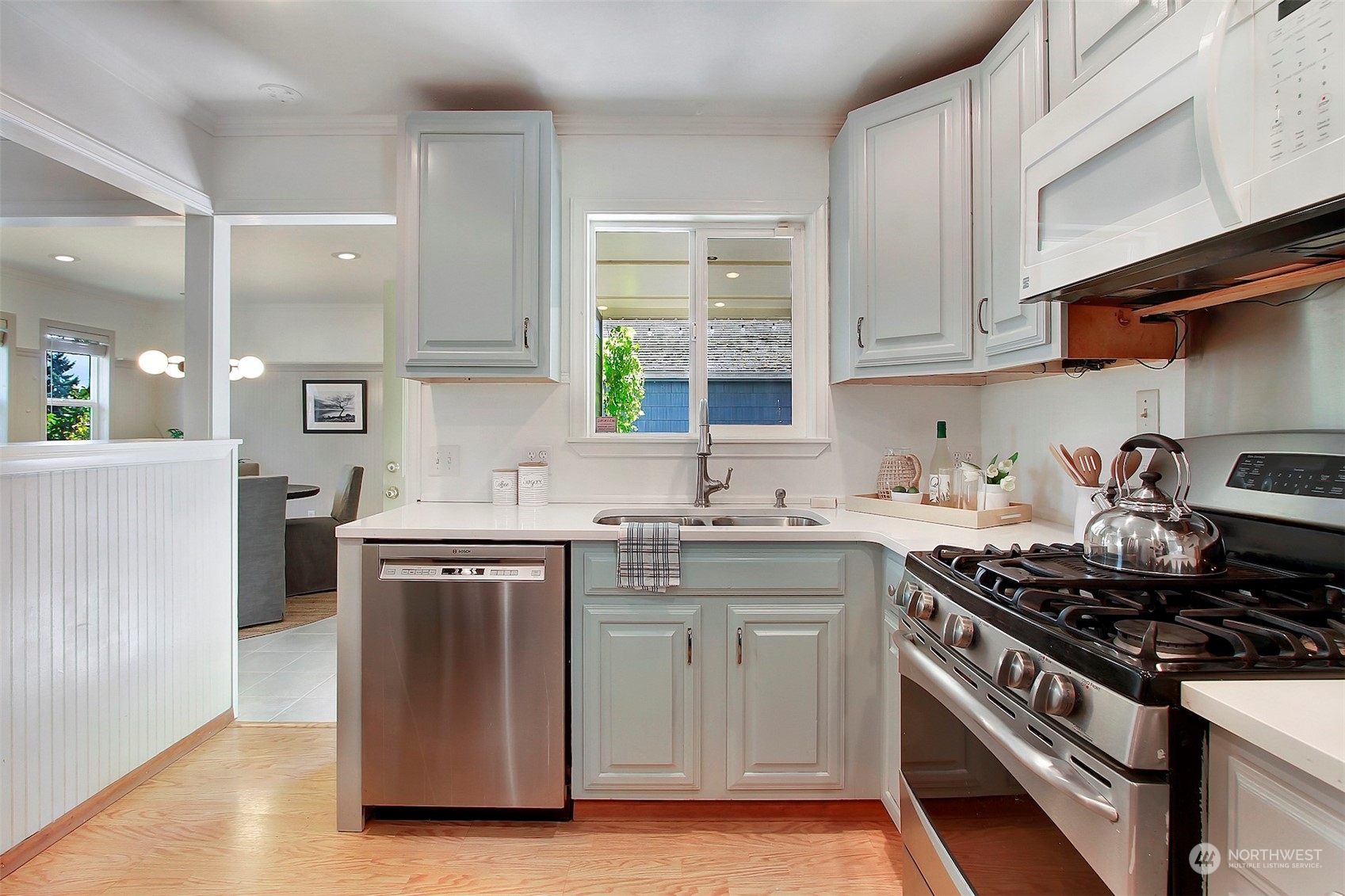 9913 32nd Avenue Southwest Seattle, WA 98126 - Photo 14 of 29 a kitchen with stainless steel appliances a sink stove and cabinets
