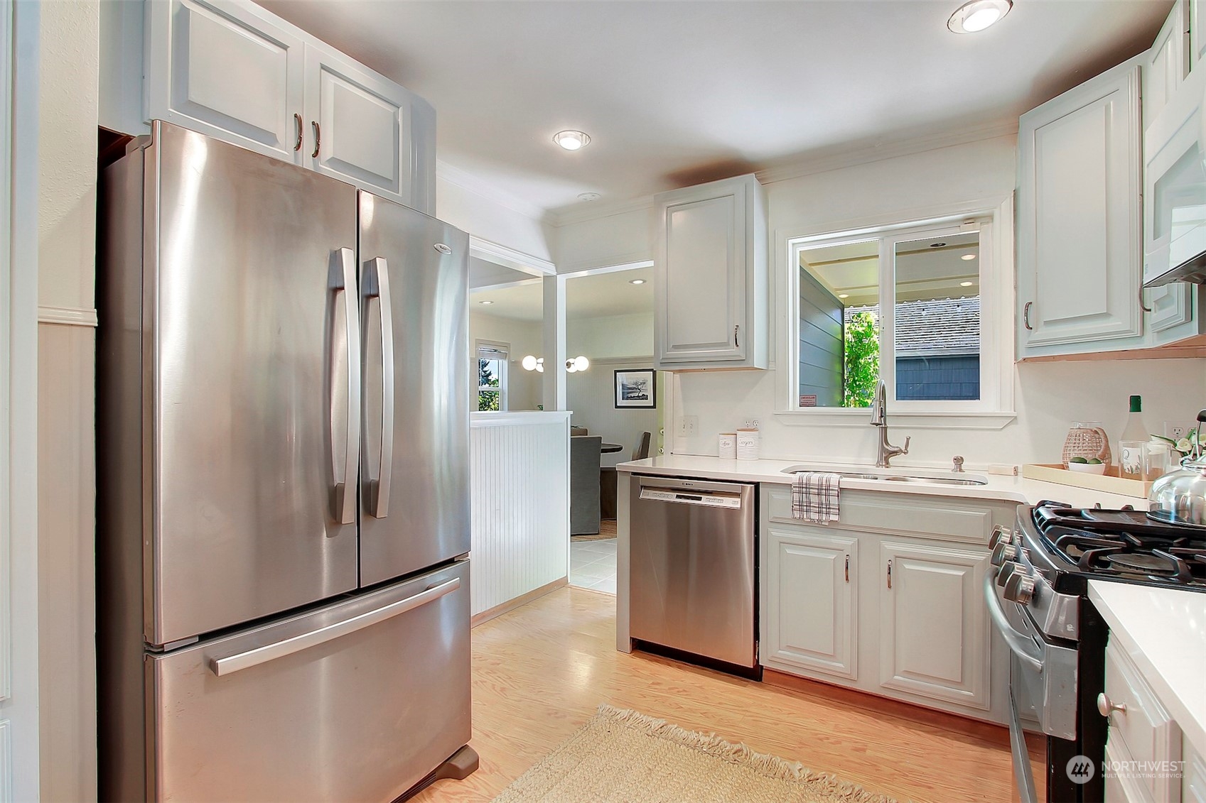 9913 32nd Avenue Southwest Seattle, WA 98126 - Photo 15 of 29 a kitchen with stainless steel appliances a refrigerator sink and stove