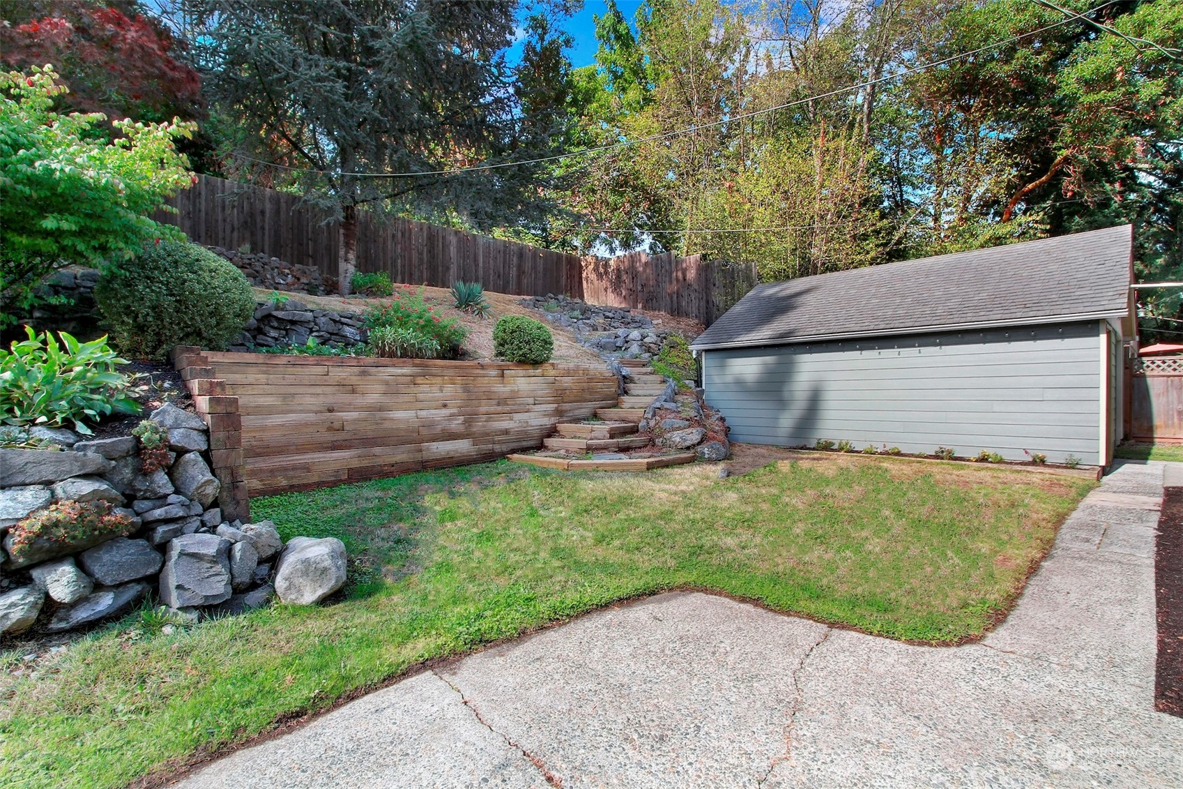 9913 32nd Avenue Southwest Seattle, WA 98126 - Photo 21 of 29 a view of a backyard with plants and a fence