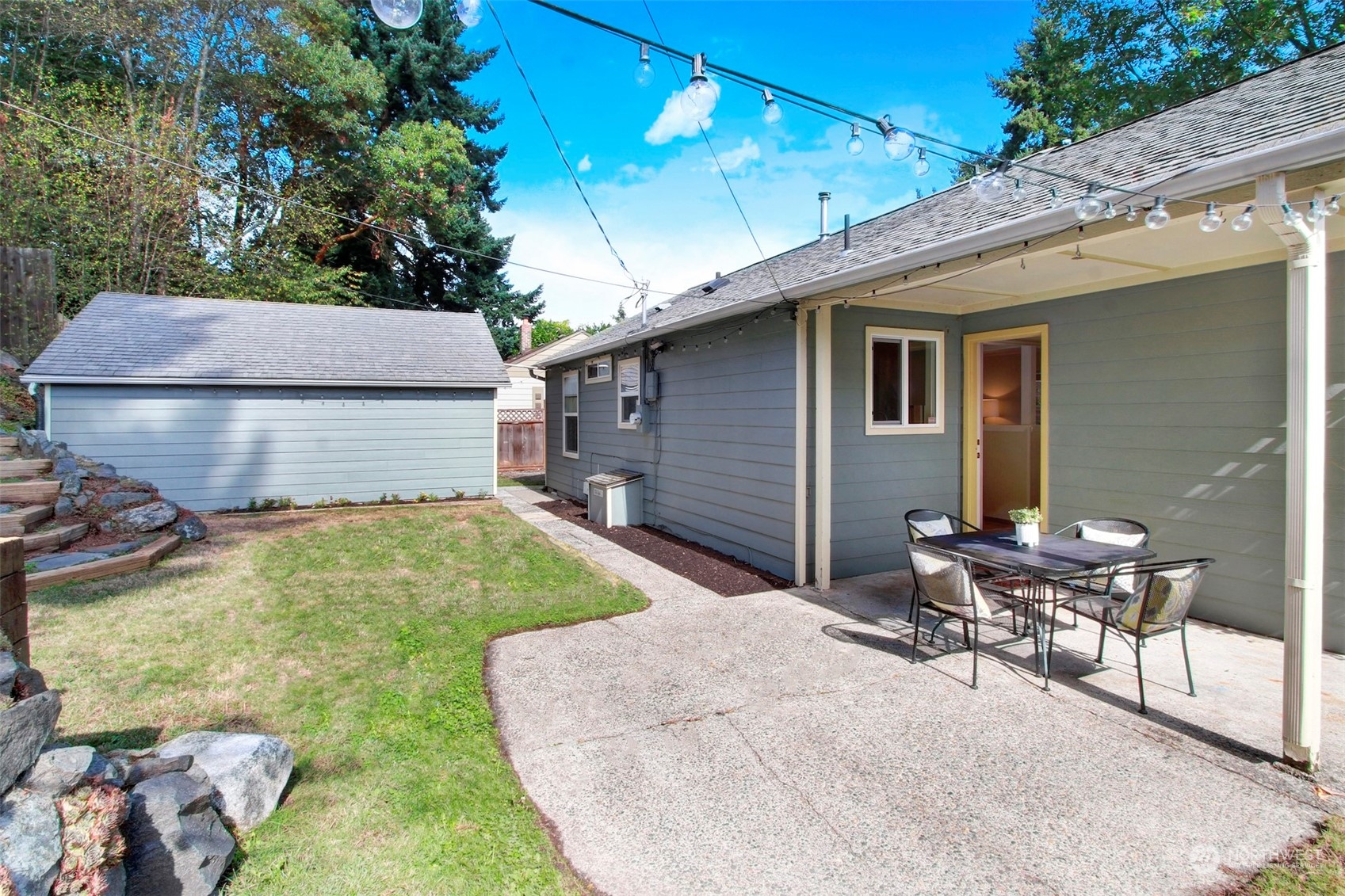 9913 32nd Avenue Southwest Seattle, WA 98126 - Photo 22 of 29 a backyard of a house with table and chairs