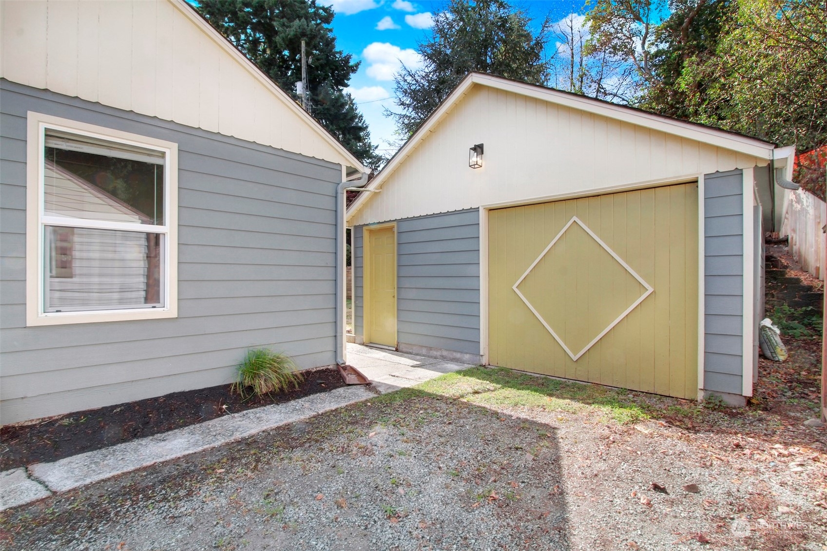 9913 32nd Avenue Southwest Seattle, WA 98126 - Photo 26 of 29 a front view of a house with a yard and garage