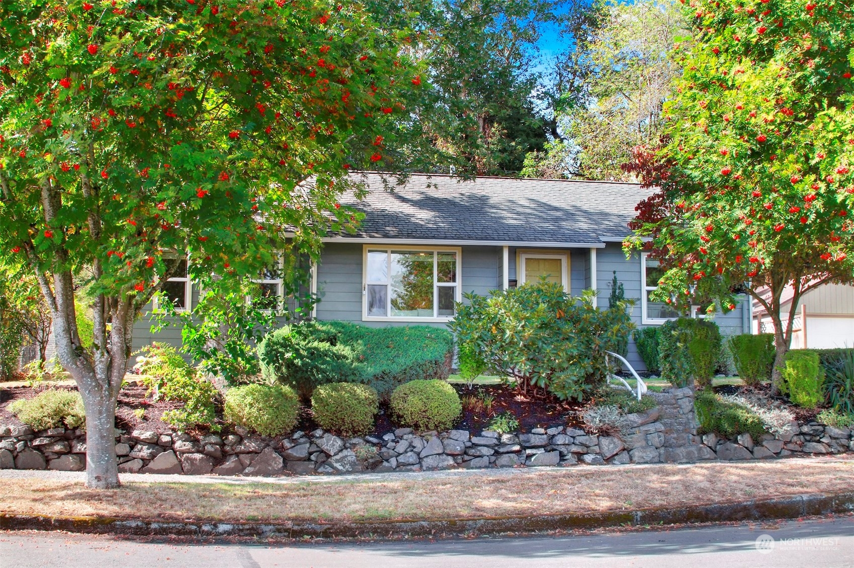 9913 32nd Avenue Southwest Seattle, WA 98126 - Photo 29 of 29 a front view of a house with a garden and plants