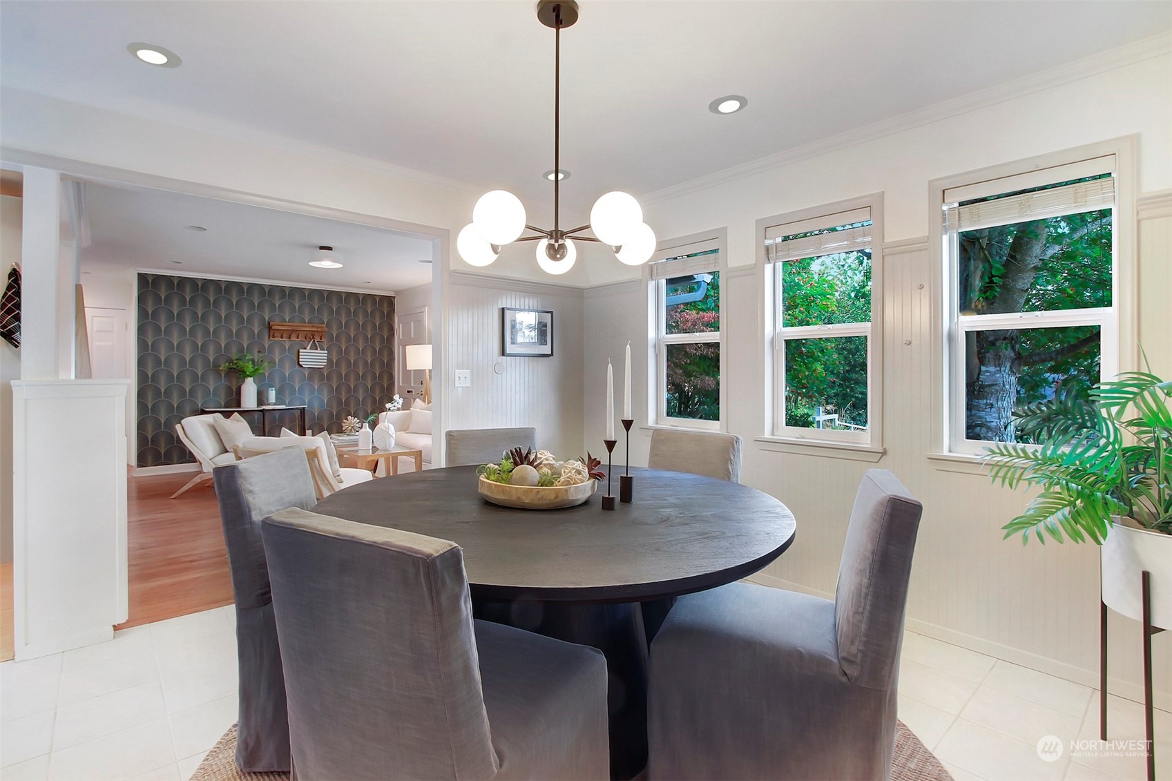 9913 32nd Avenue Southwest Seattle, WA 98126 - Photo 9 of 29 a dining room with wooden floor a chandelier a wooden table and chairs