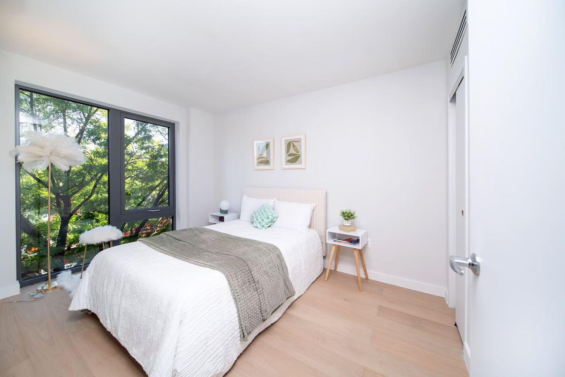 136-80 41st Avenue, Unit 7B Queens, NY 11355 - Photo 5 of 7 Bedroom with light wood-style flooring and baseboards