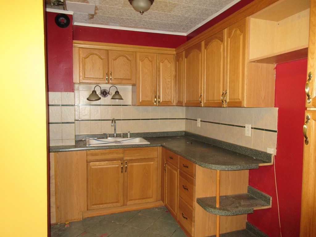 52 Huard Street Fall River, MA 02721 - Photo 4 of 17 a kitchen with a sink and cabinets