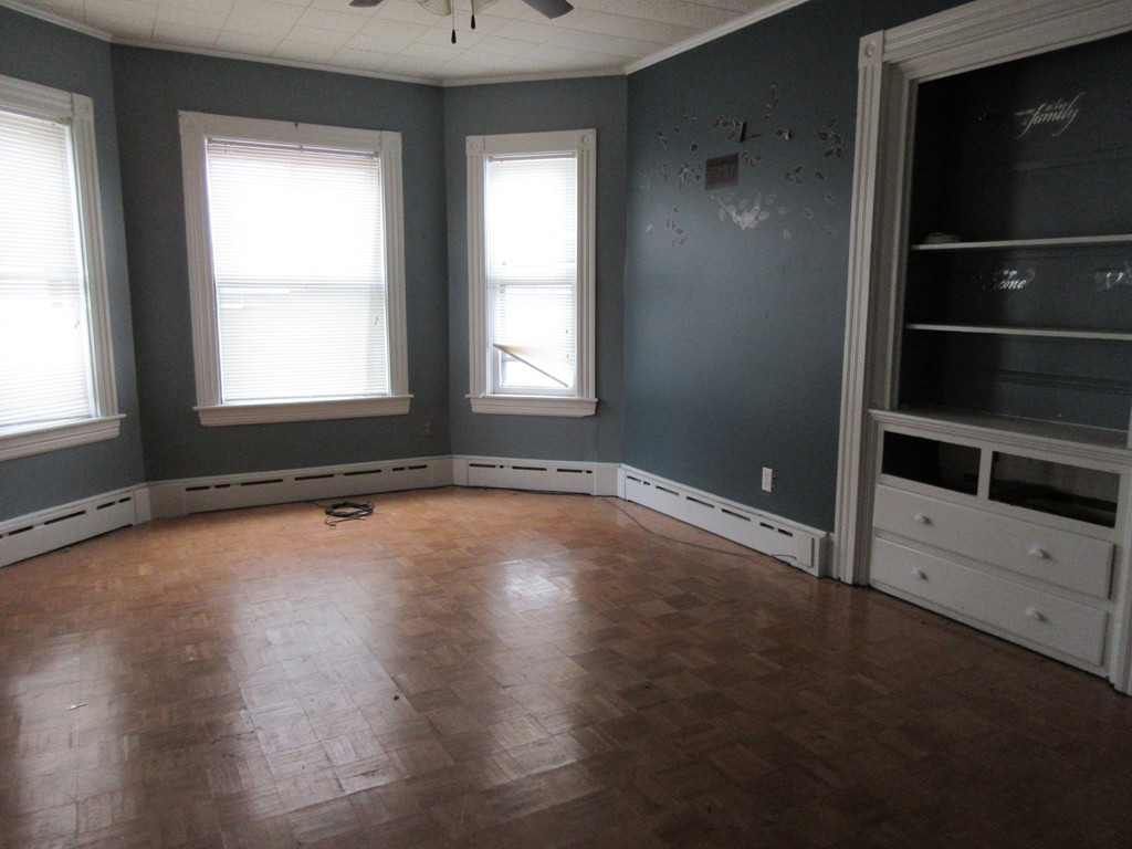 52 Huard Street Fall River, MA 02721 - Photo 6 of 17 an empty room with wooden floor and windows