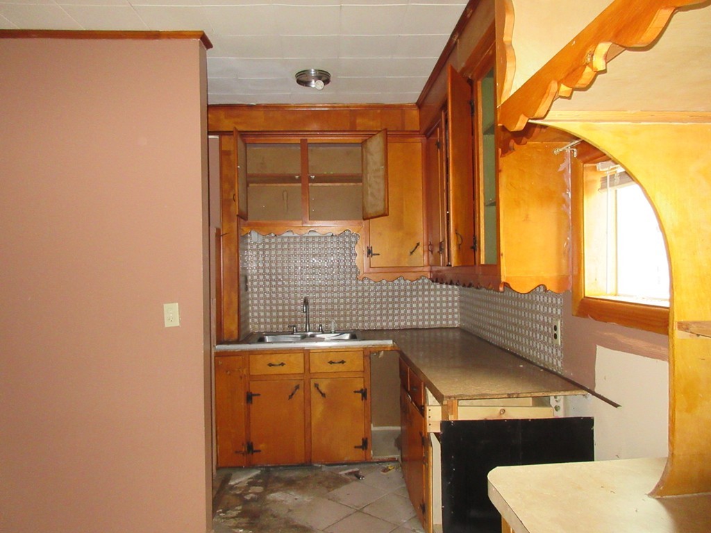 52 Huard Street Fall River, MA 02721 - Photo 8 of 17 a bathroom with a sink a toilet and a window