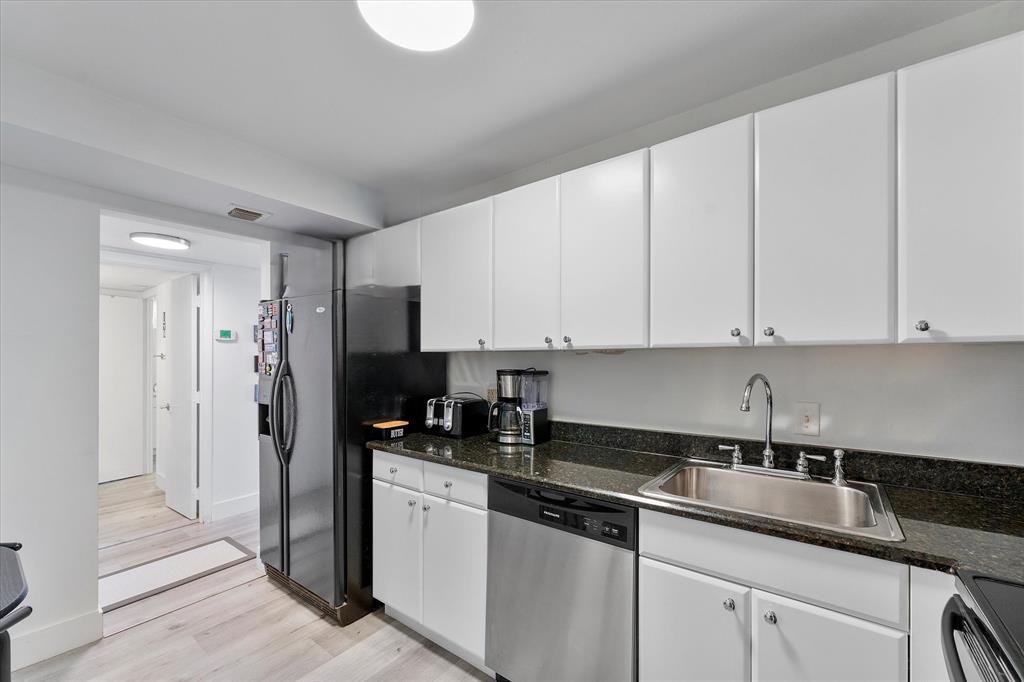 1900 South Ocean Boulevard, Unit 10J Pompano Beach, FL 33062 - Photo 13 of 36 a kitchen with stainless steel appliances granite countertop a sink a refrigerator and a granite counter tops
