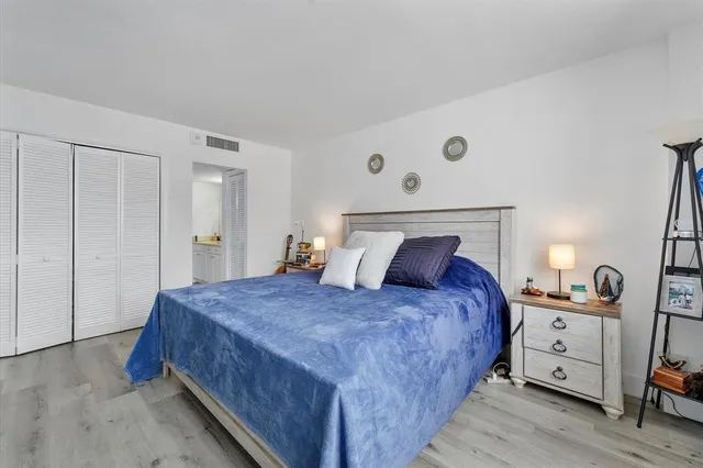 a bedroom with a bed and a closet