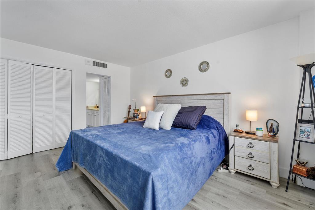 1900 South Ocean Boulevard, Unit 10J Pompano Beach, FL 33062 - Photo 16 of 36 a bedroom with a bed and a closet