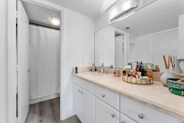 a view of a sink and cabinets in a room