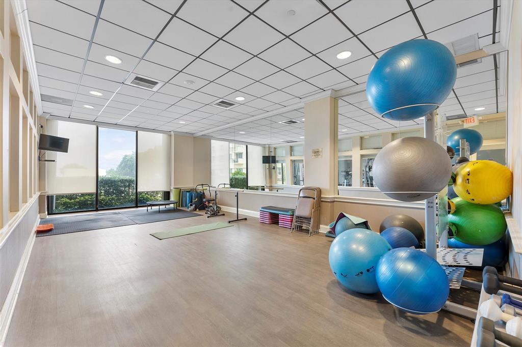 1900 South Ocean Boulevard, Unit 10J Pompano Beach, FL 33062 - Photo 23 of 36 a room with wooden cabinets and potted plant