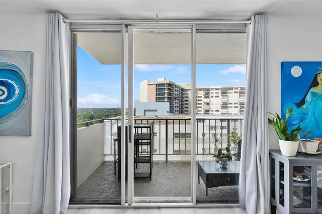 a view of a living room and a balcony