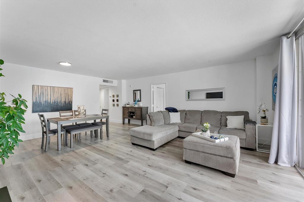 1900 South Ocean Boulevard, Unit 10J Pompano Beach, FL 33062 - Photo 9 of 36 a living room with furniture and a wooden floor