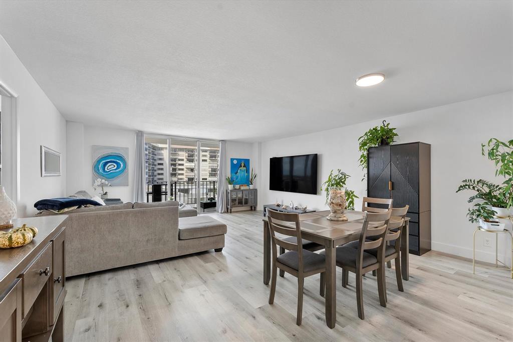 1900 South Ocean Boulevard, Unit 10J Pompano Beach, FL 33062 - Photo 10 of 36 a living room with furniture a flat screen tv and a large window