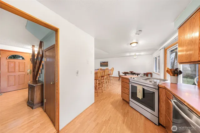 a kitchen with stainless steel appliances granite countertop a stove and a refrigerator