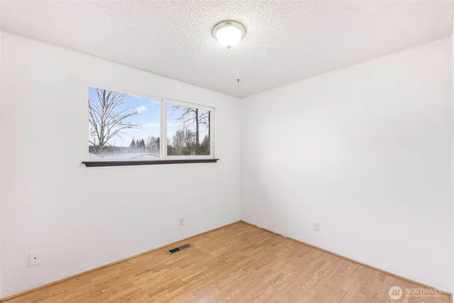 an empty room with a painting on the wall