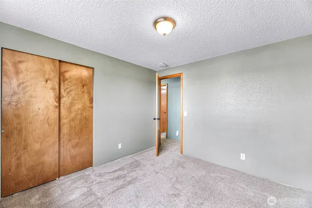 a view of an empty room and a window