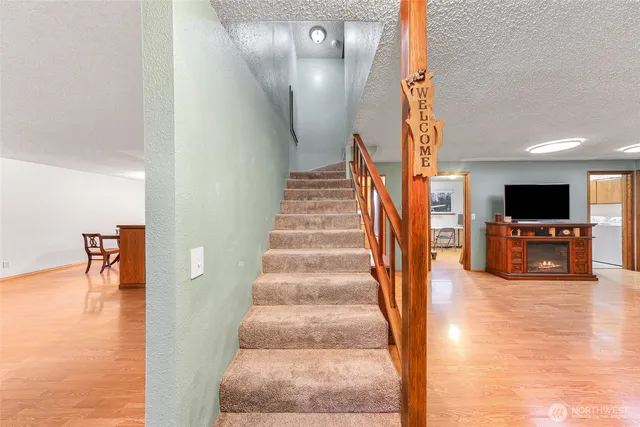 a view of entryway and hall with wooden floor