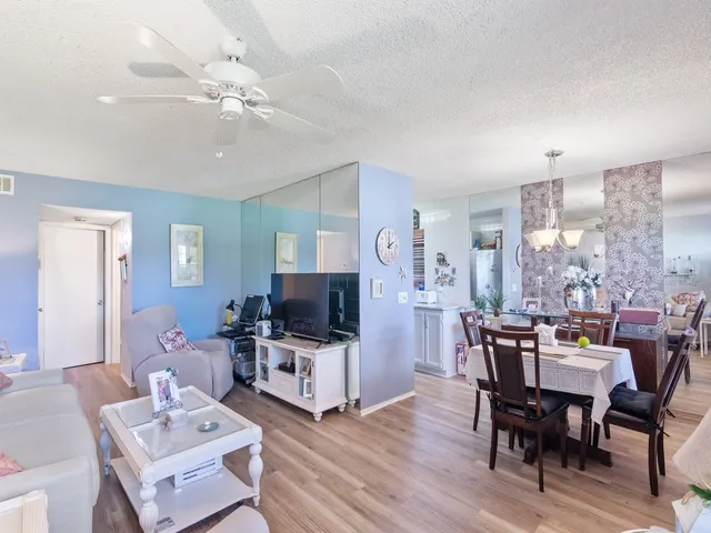 a view of a dining room with furniture and chandelier