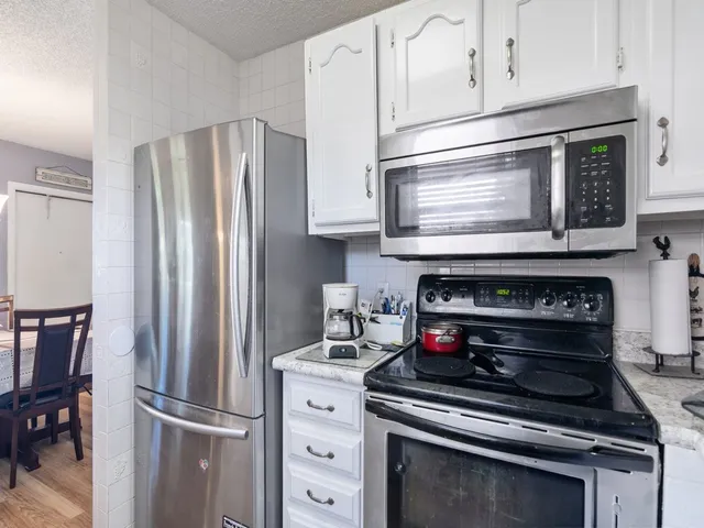 a kitchen with appliances and cabinets