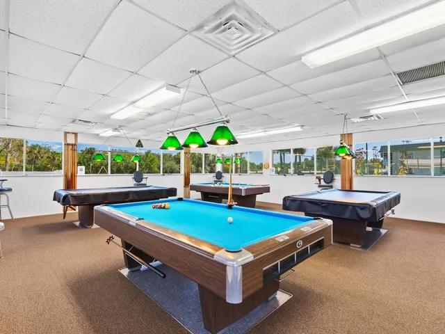 a living room with furniture a table and a large window