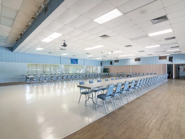 a dining room with furniture and a kitchen view