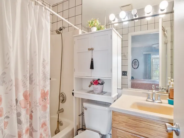 a bathroom with a sink vanity mirror and vanity