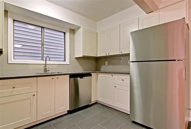 a white refrigerator freezer sitting in a kitchen
