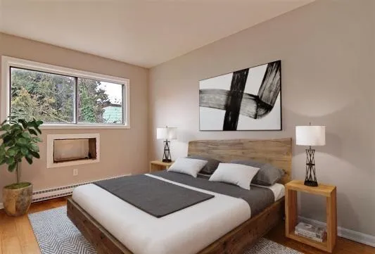 a bedroom with a large bed and a flat tv screen on a dresser