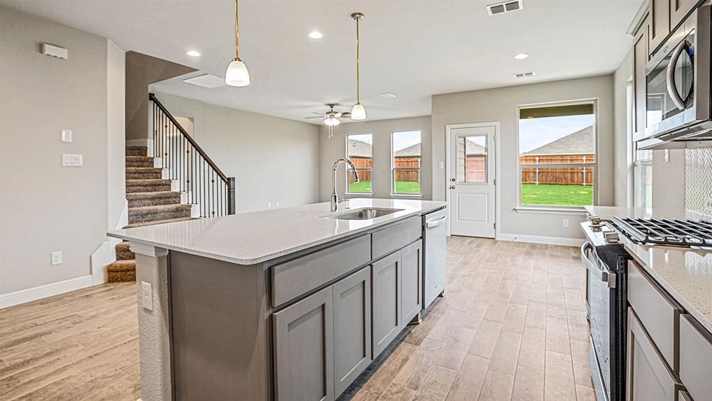 14517 Caelum Drive Haslet, TX 76052 - Photo 4 of 18 a kitchen with a stove and a sink