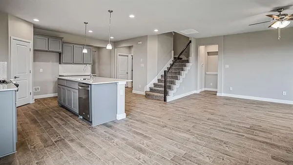 a kitchen with stainless steel appliances a stove top oven a sink and a refrigerator