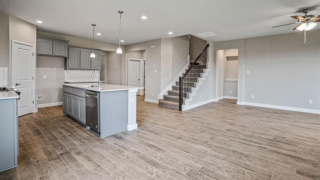 14517 Caelum Drive Haslet, TX 76052 - Photo 5 of 18 a kitchen with stainless steel appliances a stove top oven a sink and a refrigerator