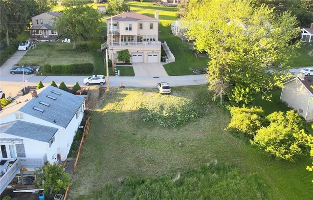 an aerial view of a house with a garden and swimming pool