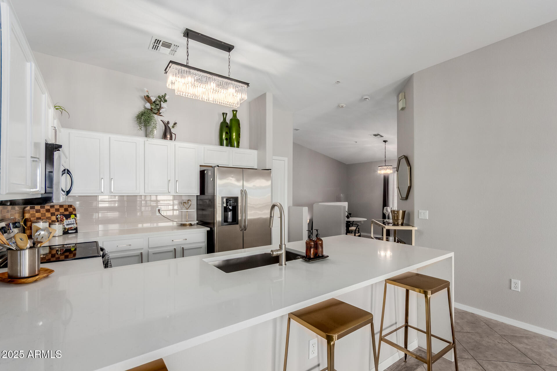 2401 East Rio Salado Parkway, Unit 1106 Tempe, AZ 85288 - Photo 12 of 40 a kitchen with stainless steel appliances kitchen island granite countertop a sink and cabinets