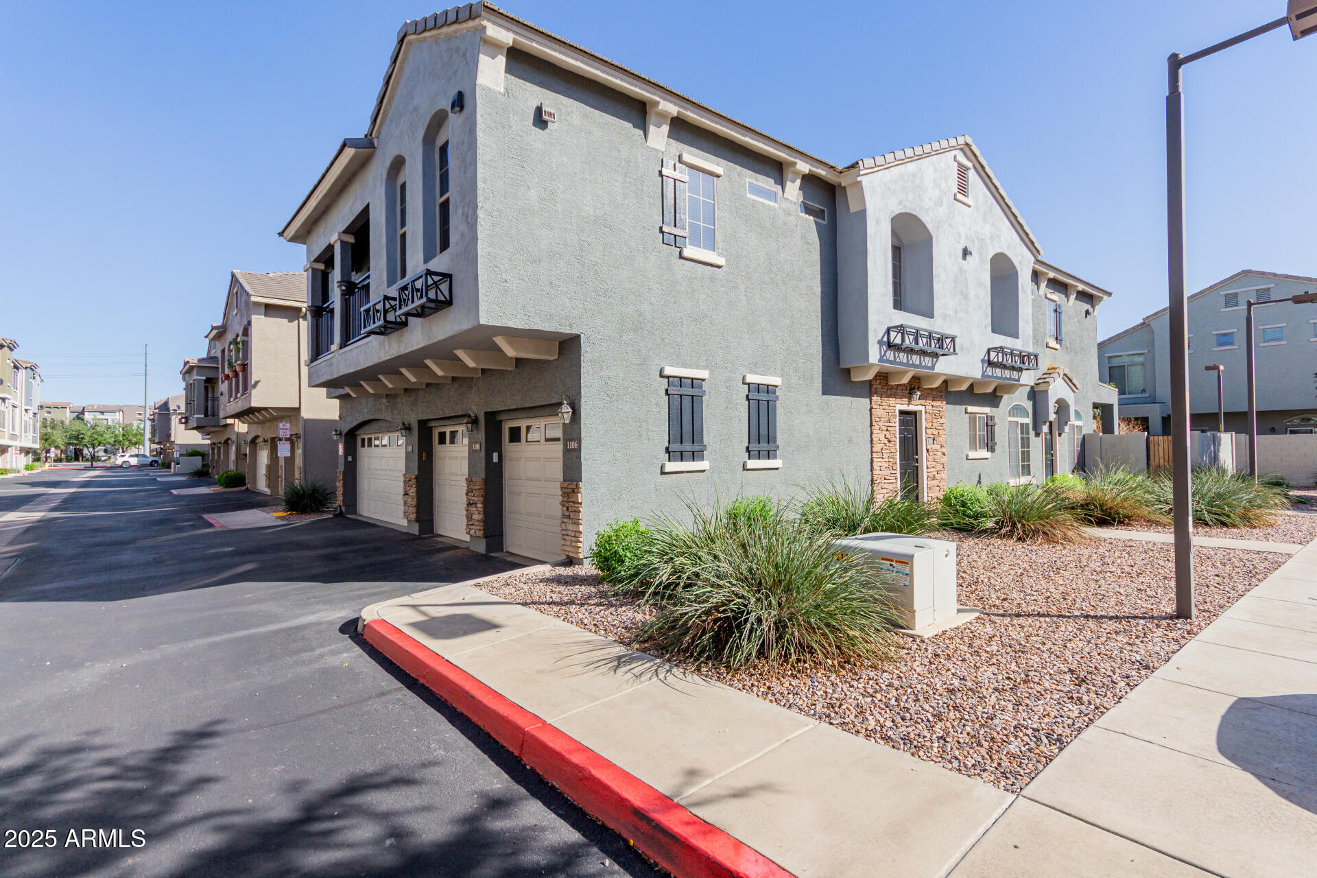 2401 East Rio Salado Parkway, Unit 1106 Tempe, AZ 85288 - Photo 2 of 40 a view of a white building among the street with palm trees