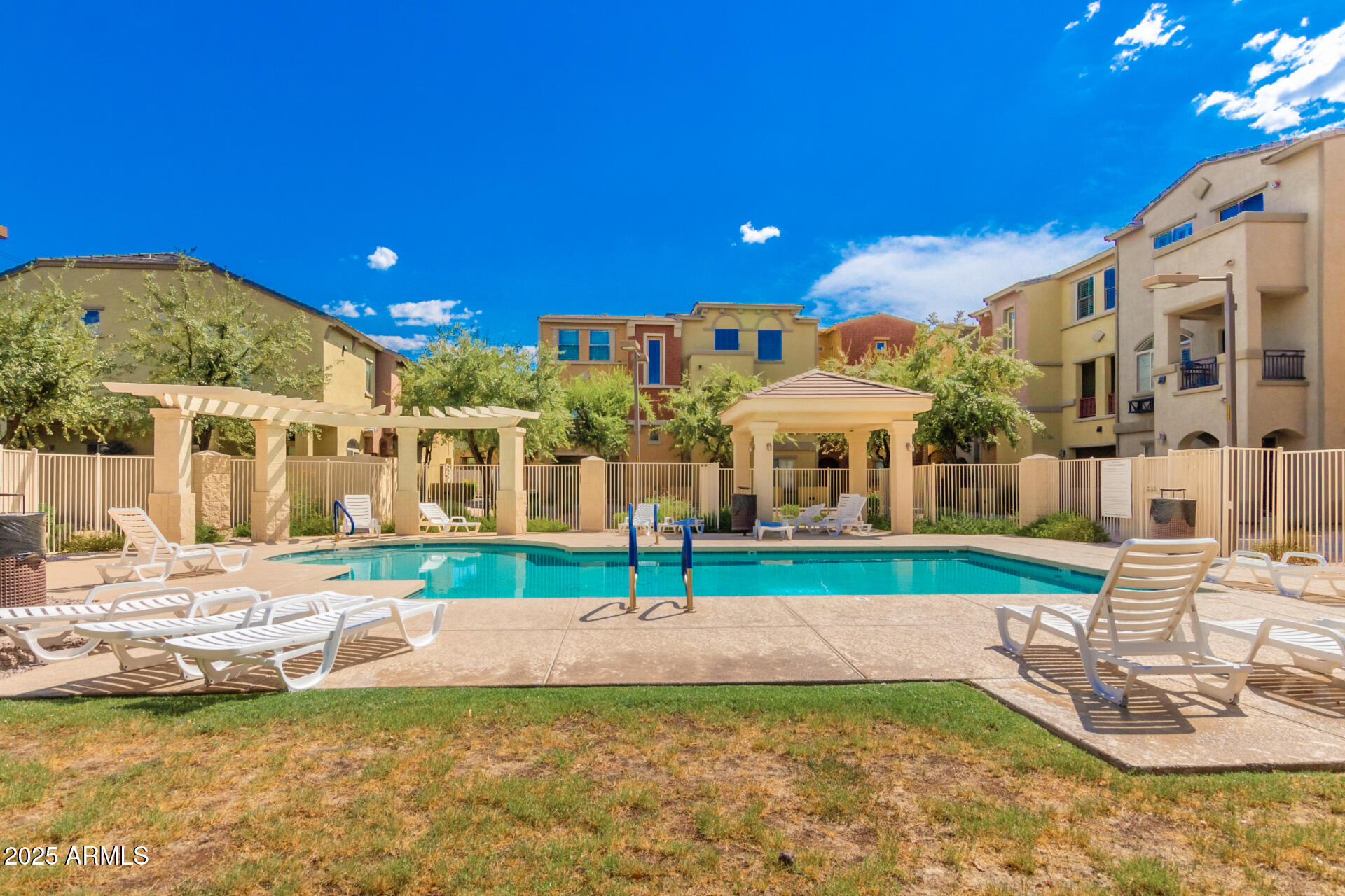2401 East Rio Salado Parkway, Unit 1106 Tempe, AZ 85288 - Photo 33 of 40 a view of a house with swimming pool and a yard